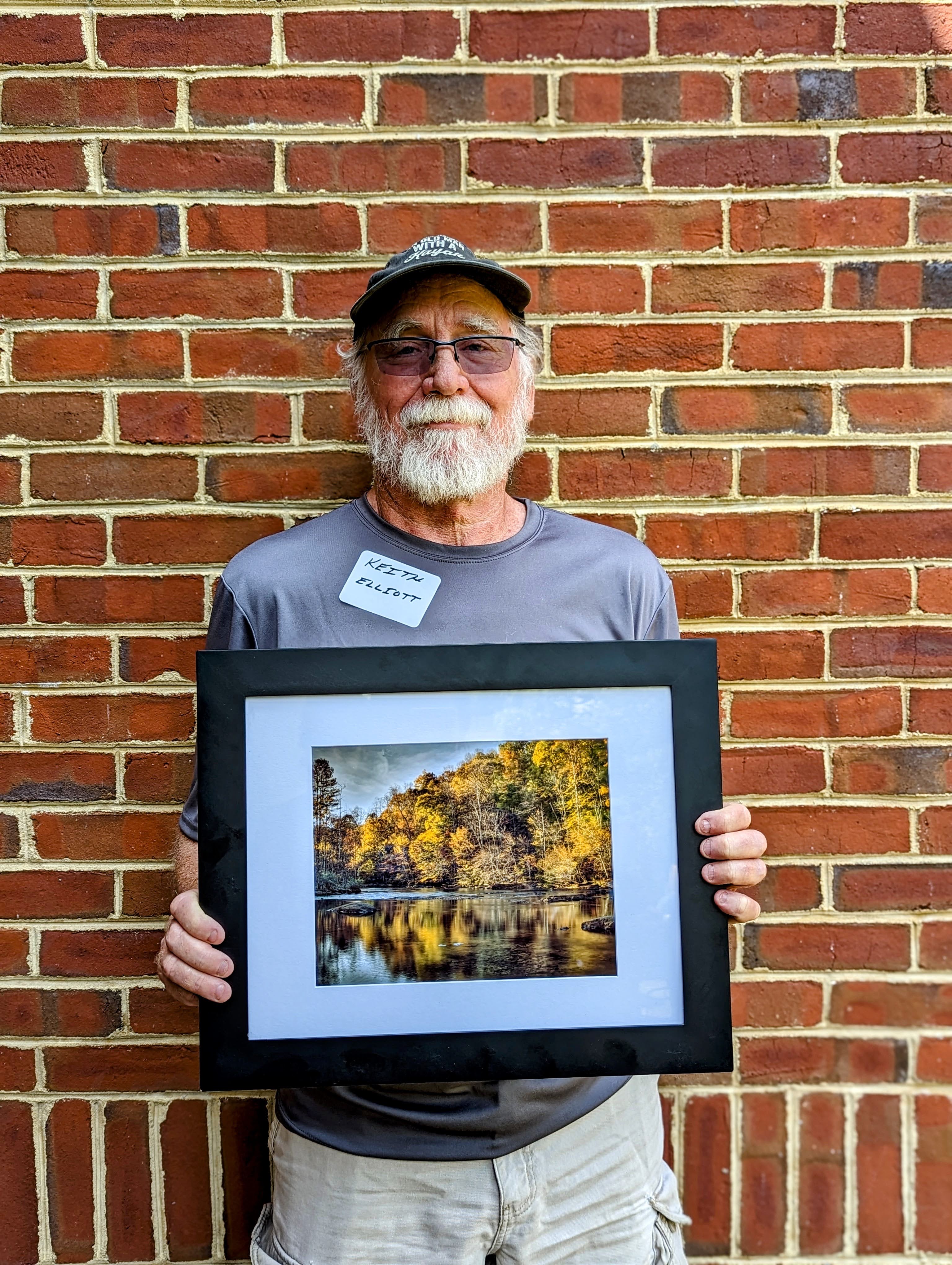Keith, service to DRBA award, is presented a beautiful photo of the river in the fall