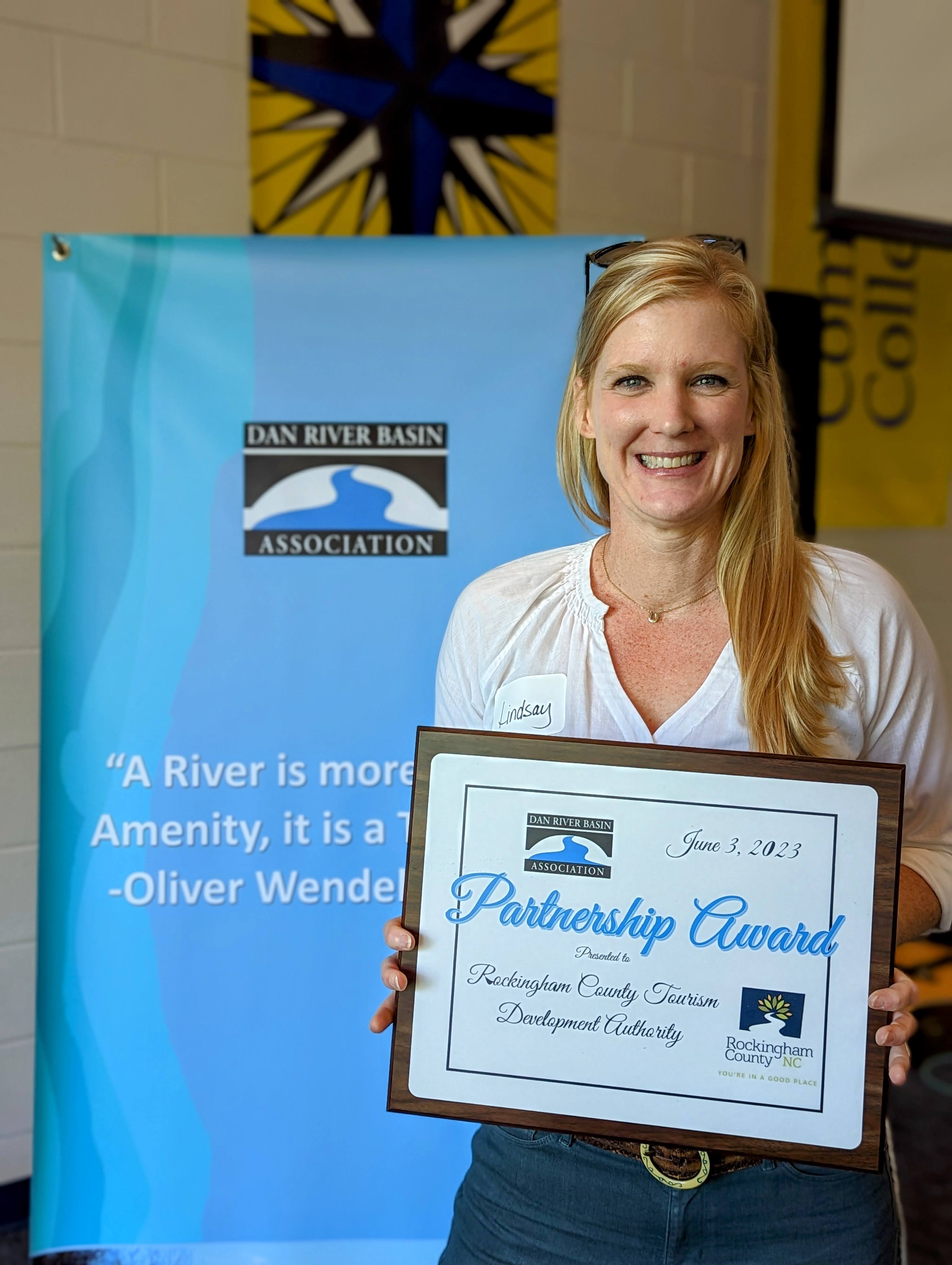 Rockingham County TDA Manager, Lindsay Pegg, holding partnership award