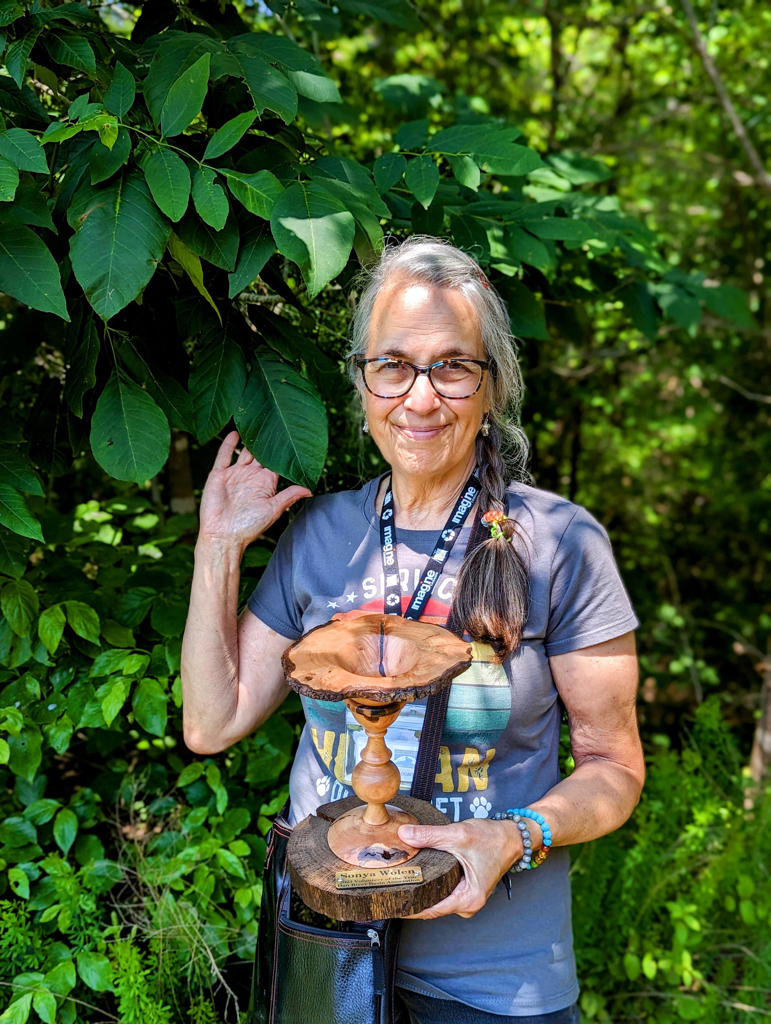 Sonya holding the Volunteer of the Year award